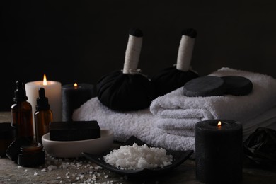 Photo of Composition with different spa products and burning candles on grey textured table