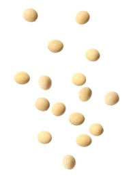 Image of Many soy beans falling on white background. Vegan diet  