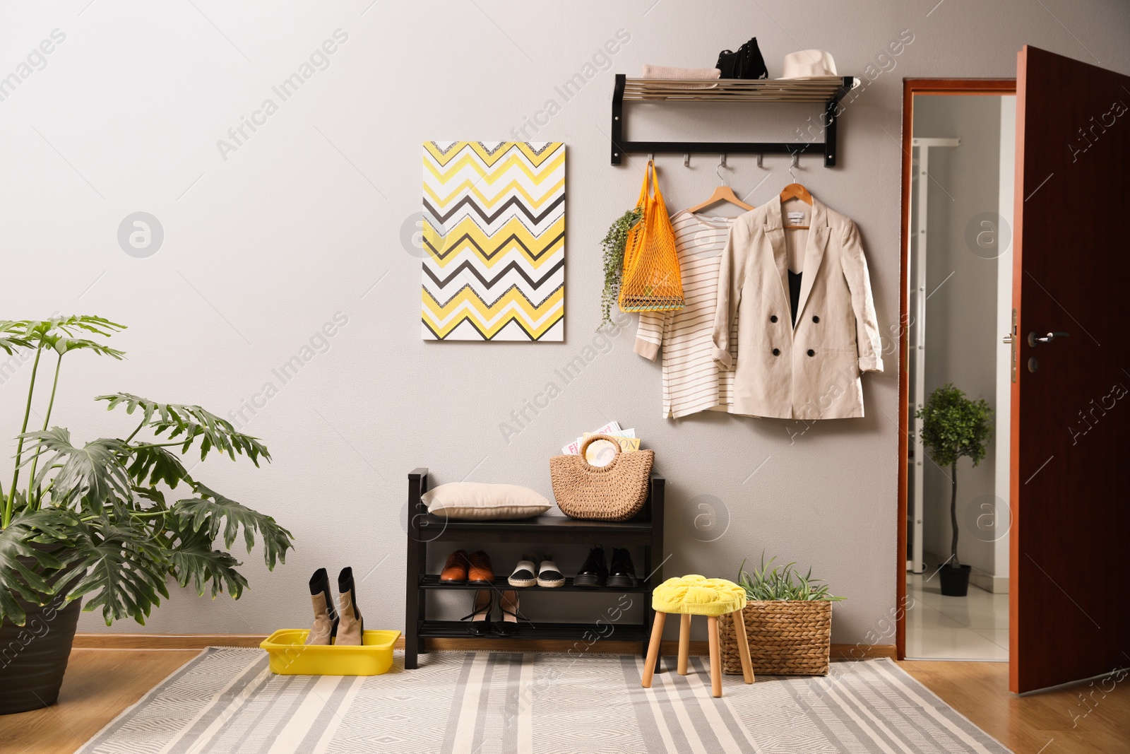 Photo of Hallway interior with stylish furniture, clothes and accessories