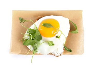 Delicious sandwich with arugula and fried egg isolated on white, top view