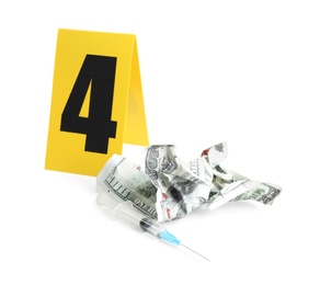 Photo of Bloody crumpled dollar, syringe and crime scene marker with number four isolated on white