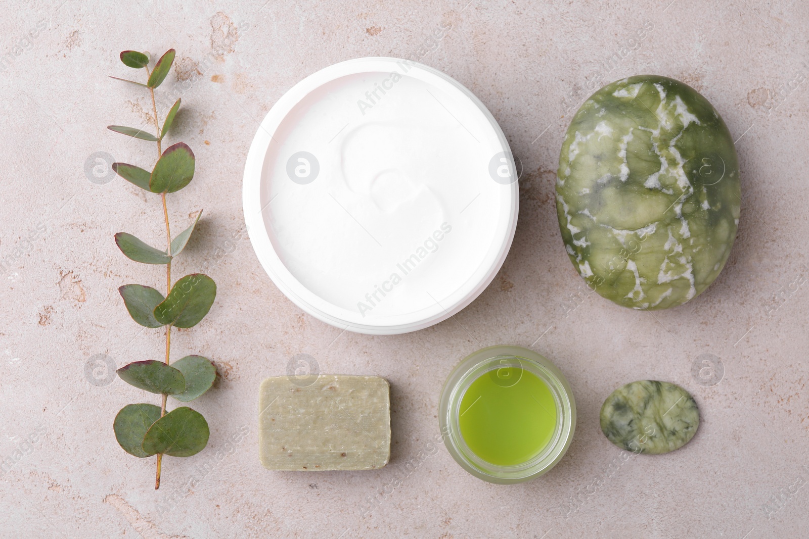 Photo of Flat lay composition with jars of cream on light textured table. Body care products