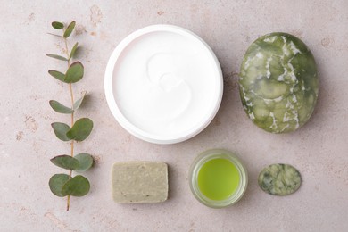 Flat lay composition with jars of cream on light textured table. Body care products