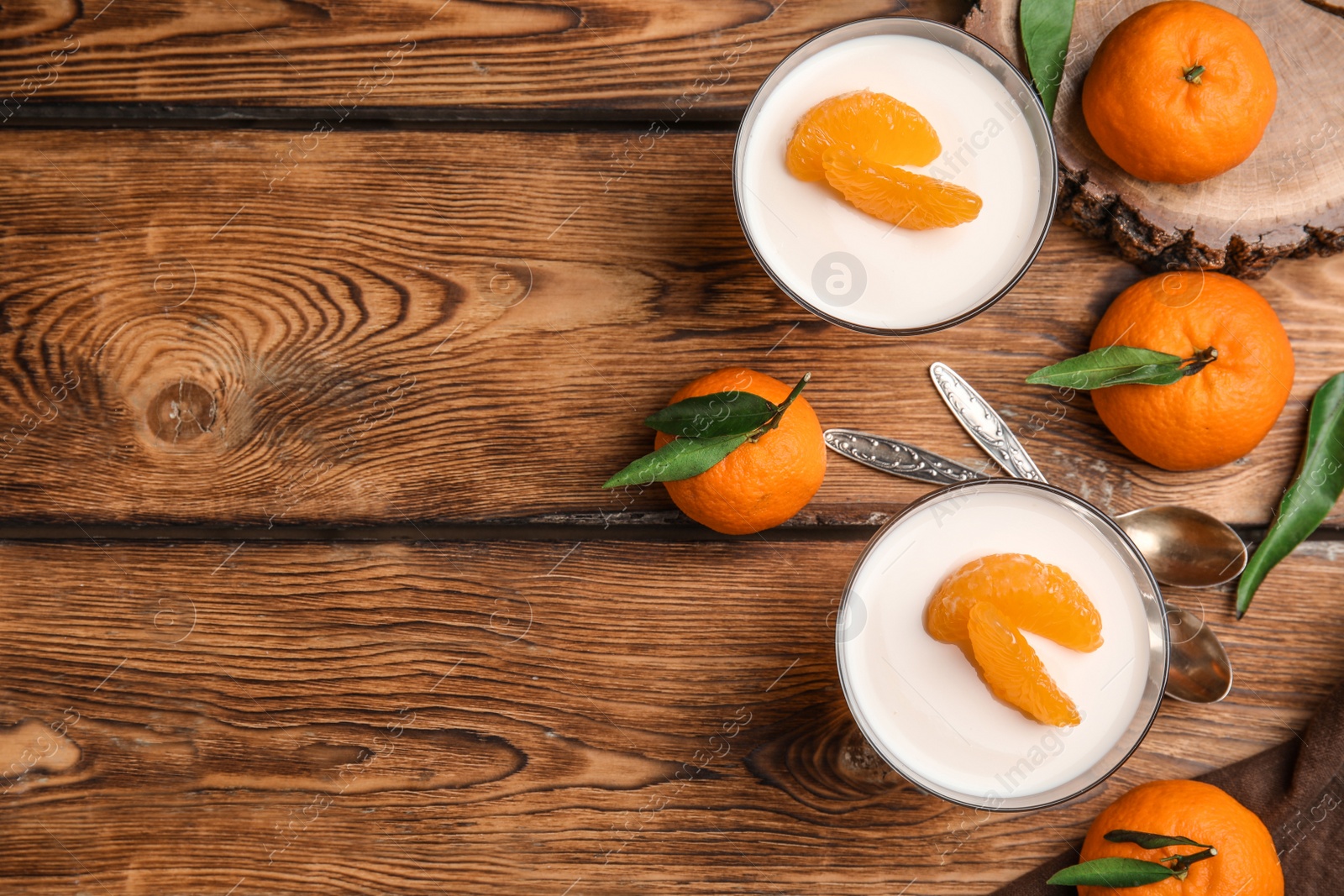 Photo of Delicious tangerine jelly and fresh fruits on wooden table, flat lay. Space for text