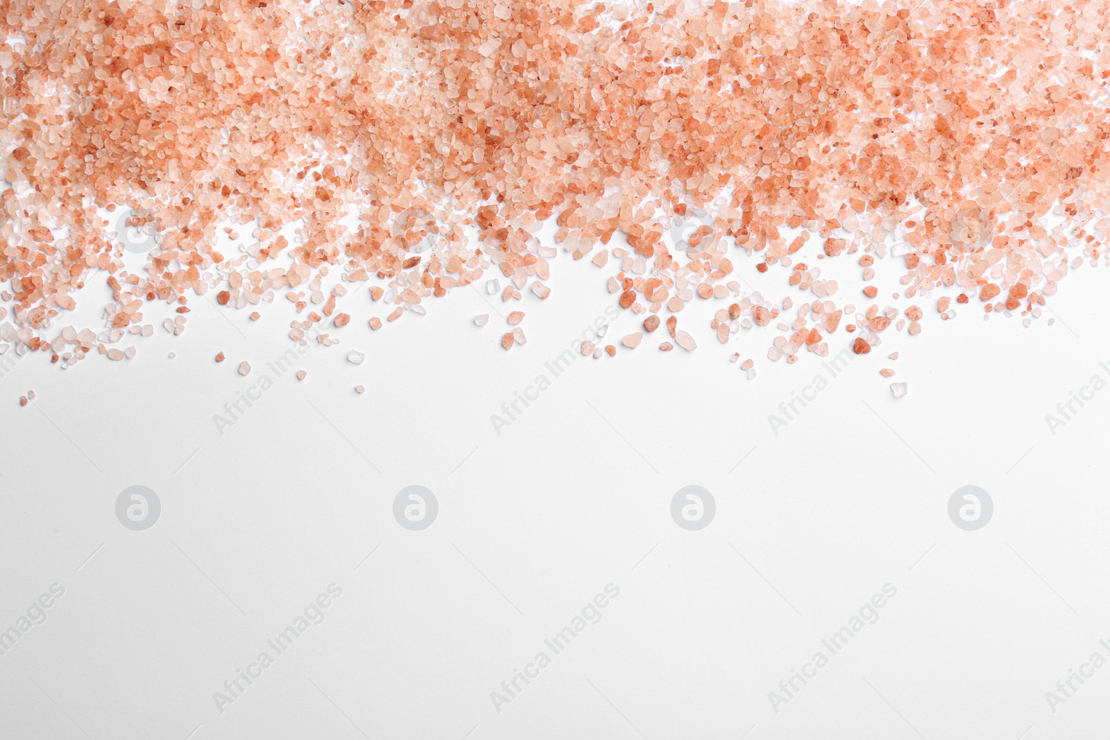 Photo of Pink himalayan salt isolated on white, top view