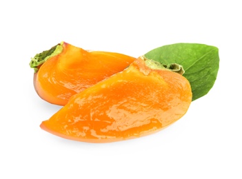 Photo of Slices of delicious persimmon and green leaf isolated on white