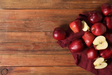 Photo of Fresh ripe red apples on wooden table, flat lay. Space for text