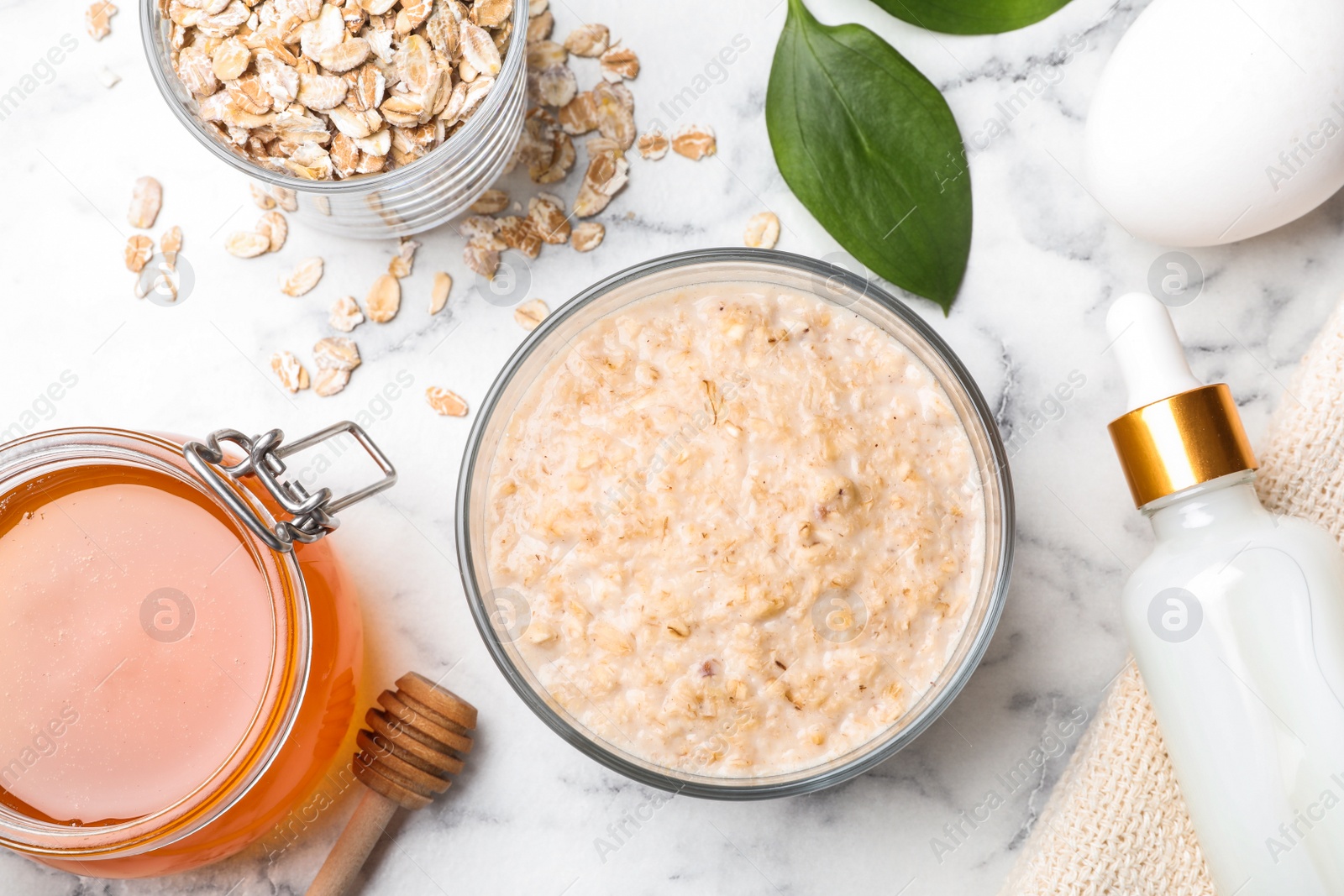 Photo of Handmade face mask and ingredients on white marble table, flat lay