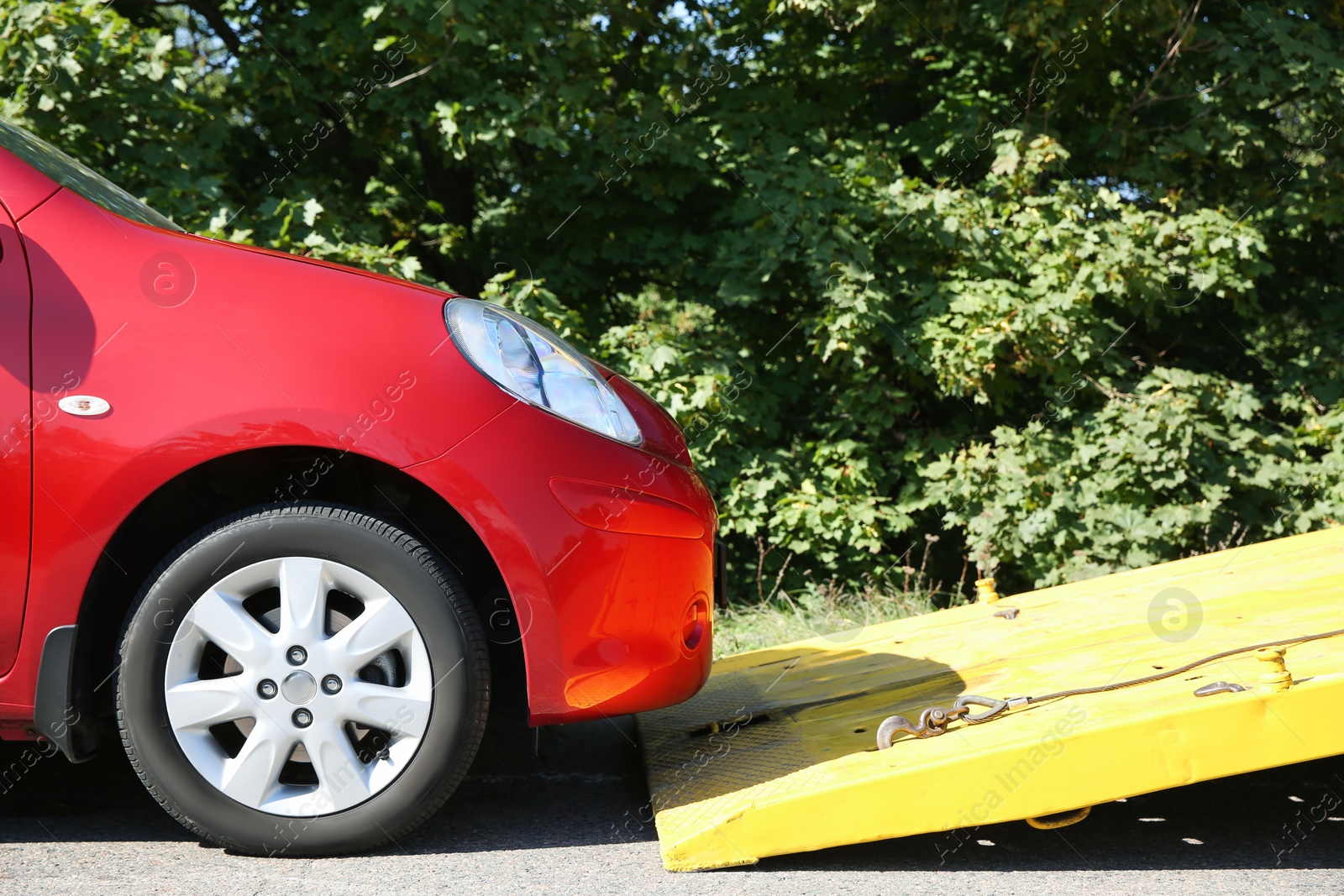 Photo of Broken car and tow truck on country road