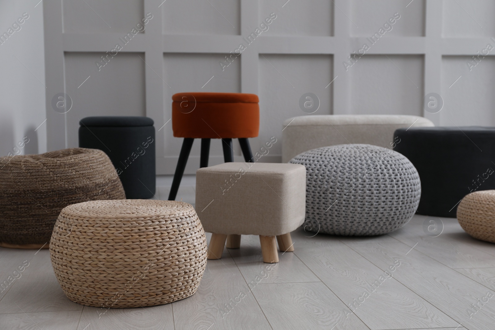 Photo of Different stylish poufs and ottomans in room