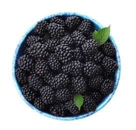 Blue bowl of tasty ripe blackberries with leaves on white background, top view