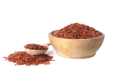 Photo of Bowl and spoon with uncooked brown rice on white background