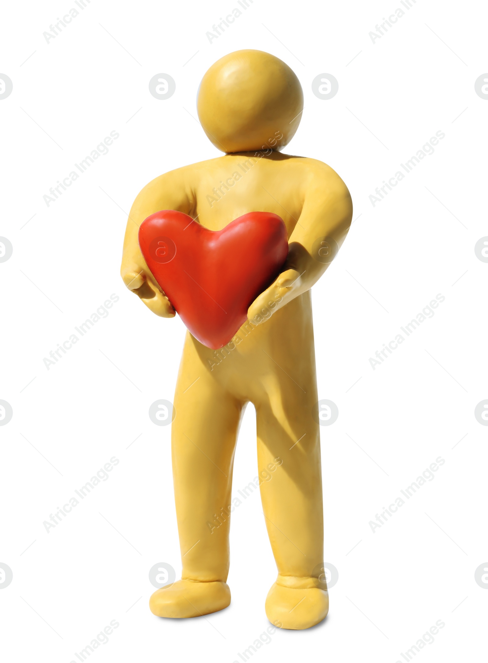 Photo of Yellow plasticine human figure with pink heart isolated on white