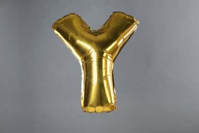 Photo of Golden letter Y balloon on grey background