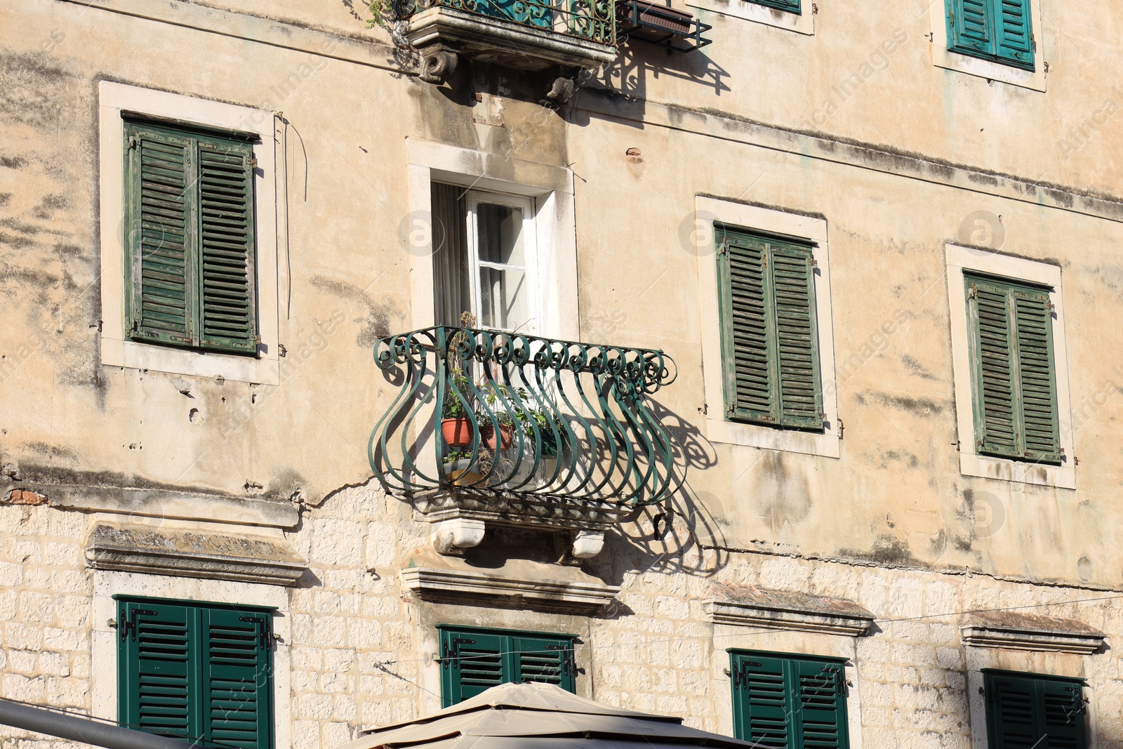 Photo of Exterior of old residential building with balcony