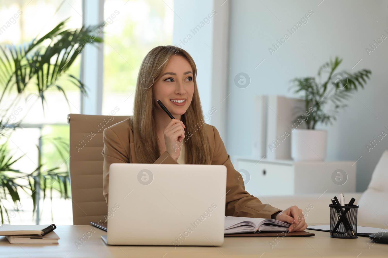 Photo of Secretary working at wooden table in office