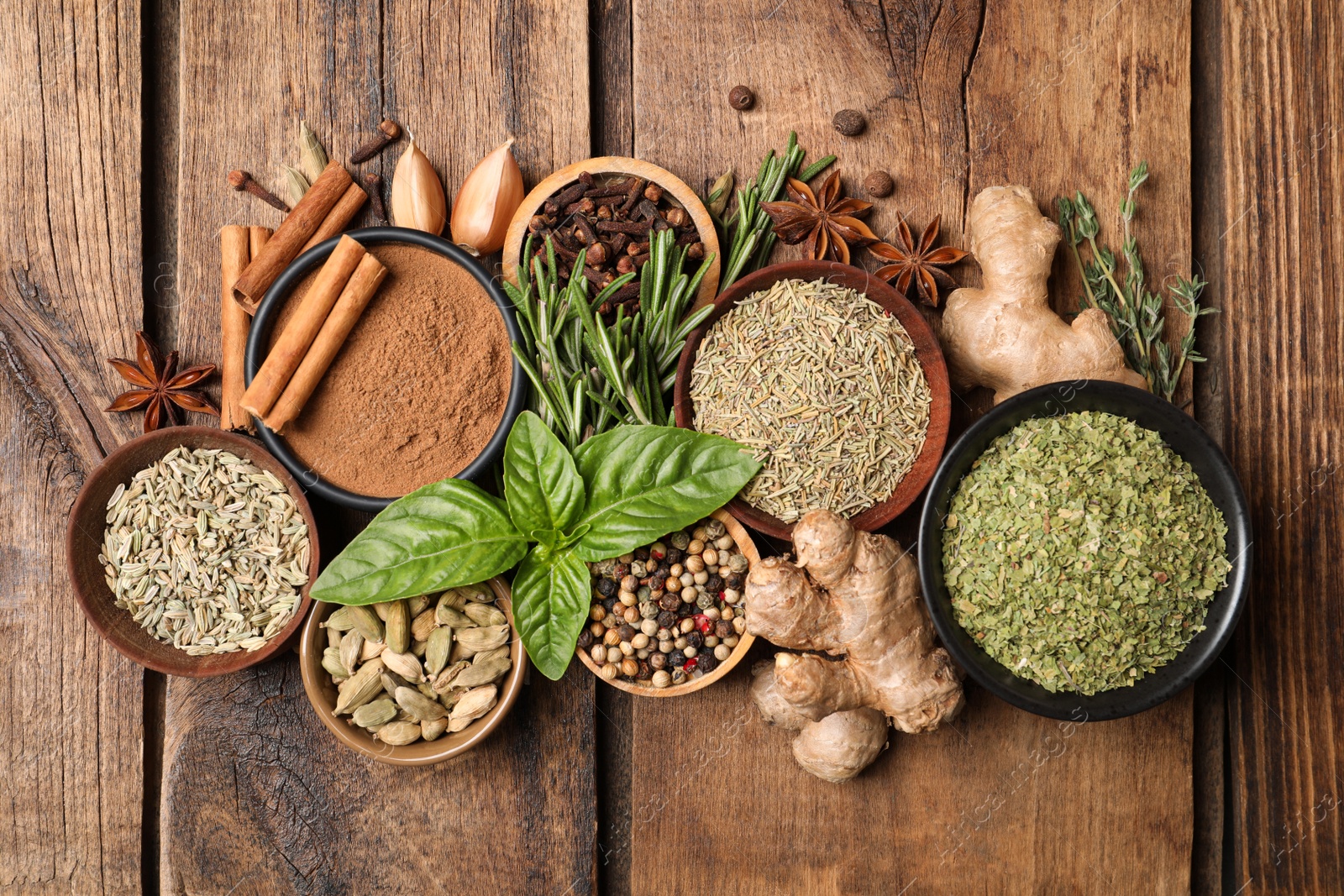 Photo of Flat lay composition with different natural spices and herbs on wooden table