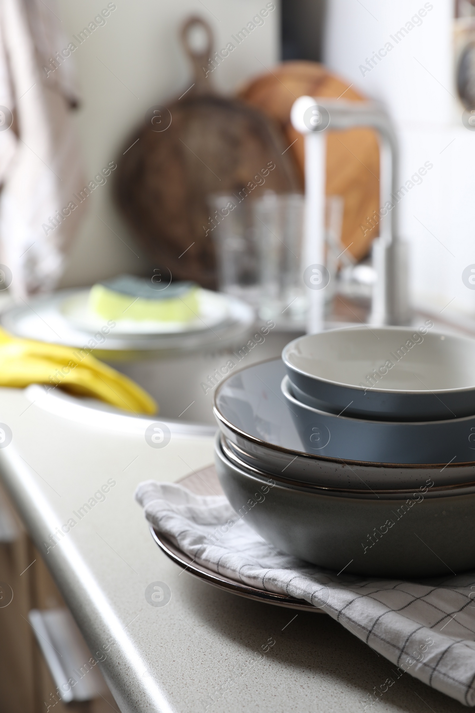 Photo of Clean bowls near kitchen sink. Washing dishes