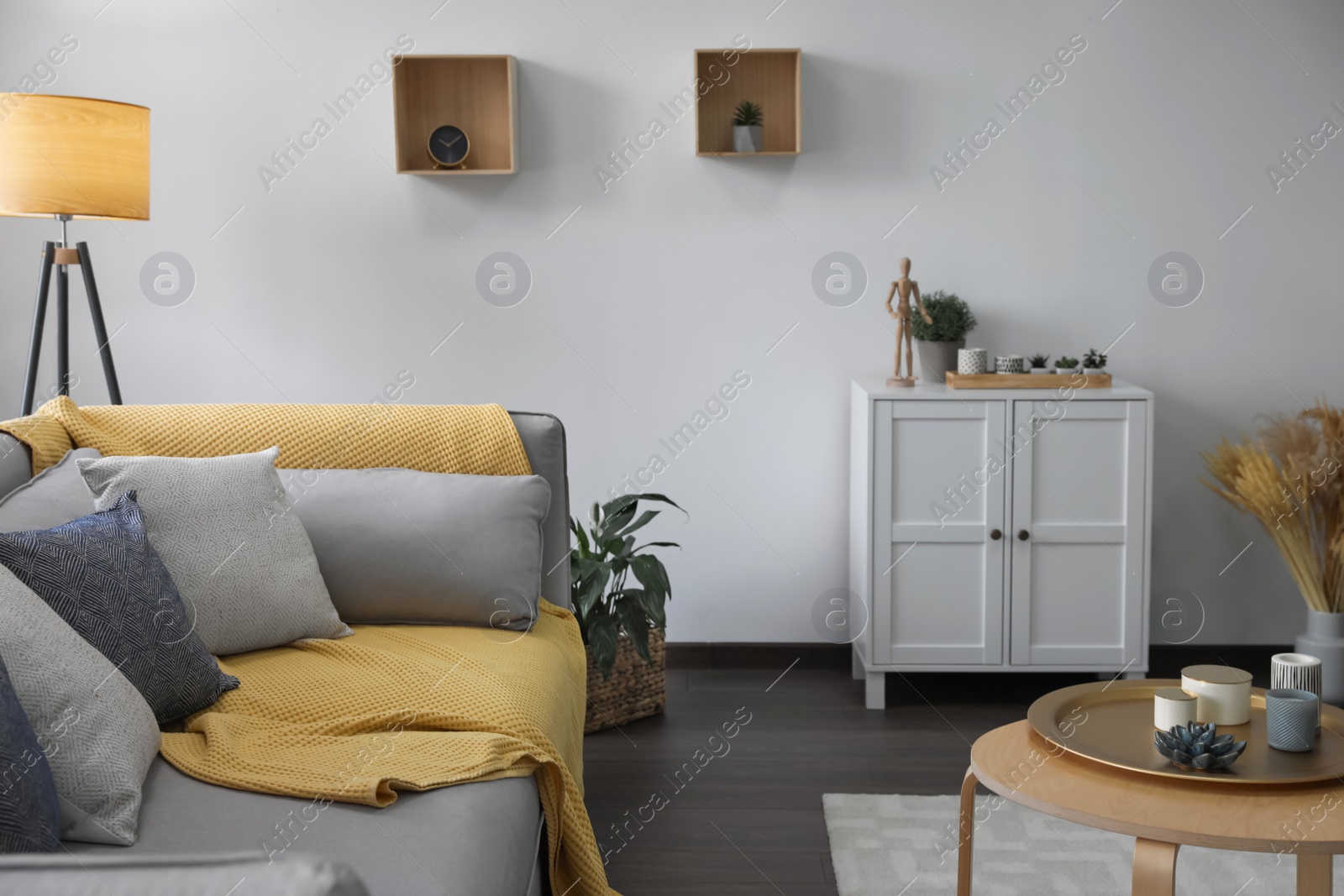 Photo of Elegant living room with comfortable sofa and wooden table. Interior design