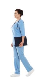 Photo of Full length portrait of female doctor in scrubs with clipboard isolated on white. Medical staff