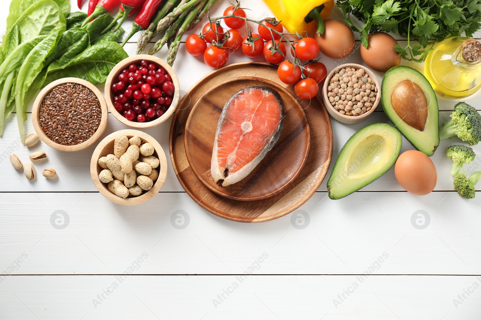 Photo of Many different healthy food on white wooden table, flat lay. Space for text