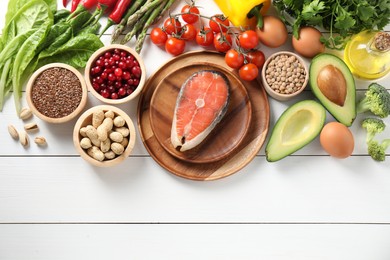 Photo of Many different healthy food on white wooden table, flat lay. Space for text