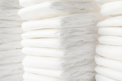 Stacks of baby diapers as background, closeup