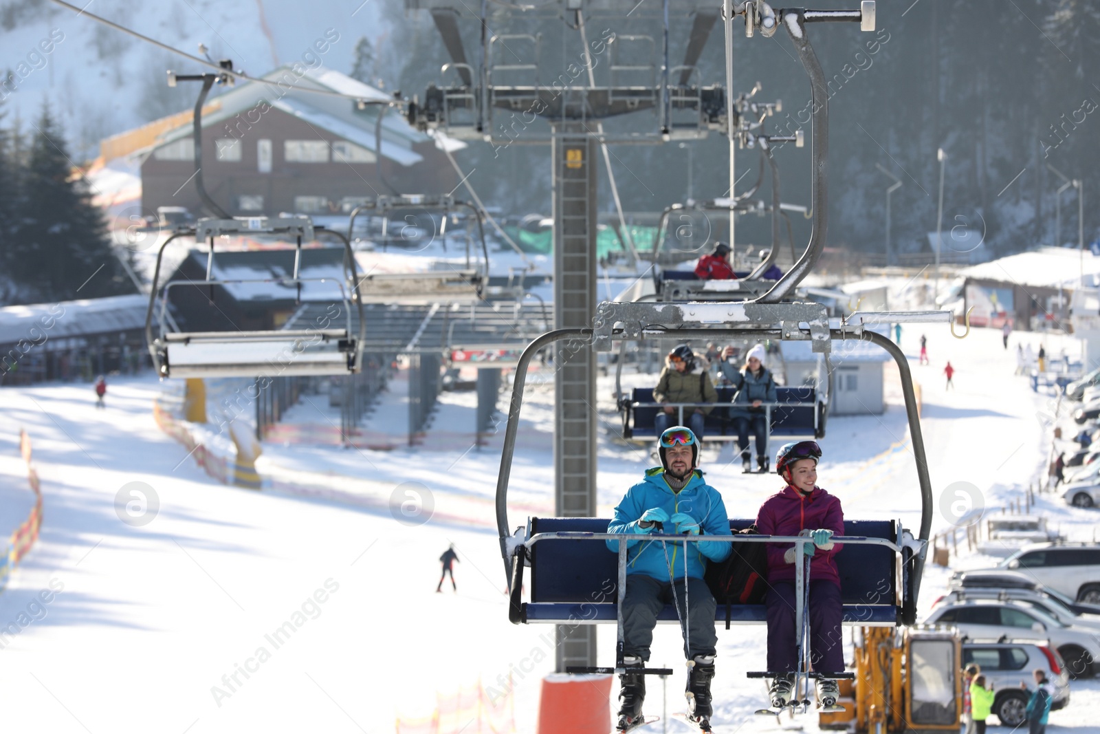 Photo of People using chairlift at mountain ski resort. Winter vacation