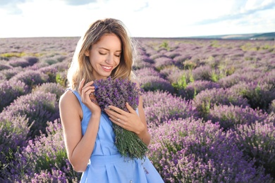 Photo of Young woman with bouquet in lavender field