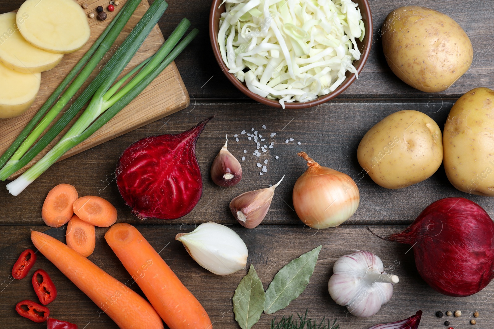 Photo of Fresh ingredients for borscht on wooden table, flat lay