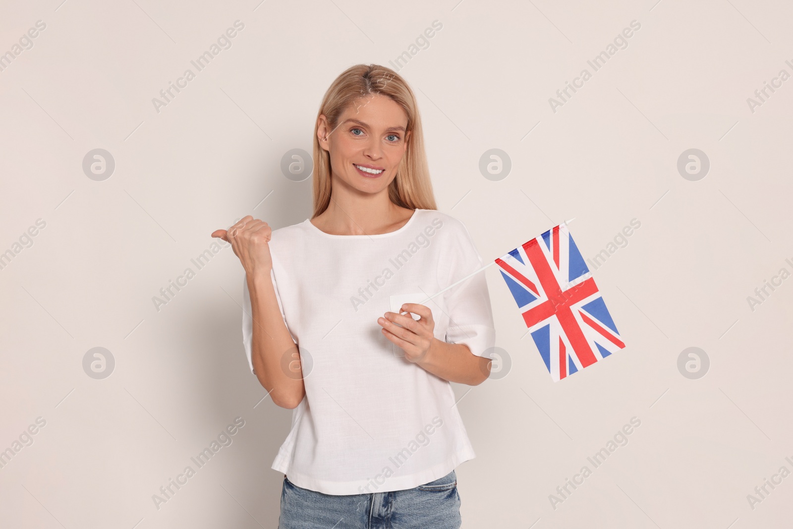 Photo of Woman with flag of United Kingdom on white background