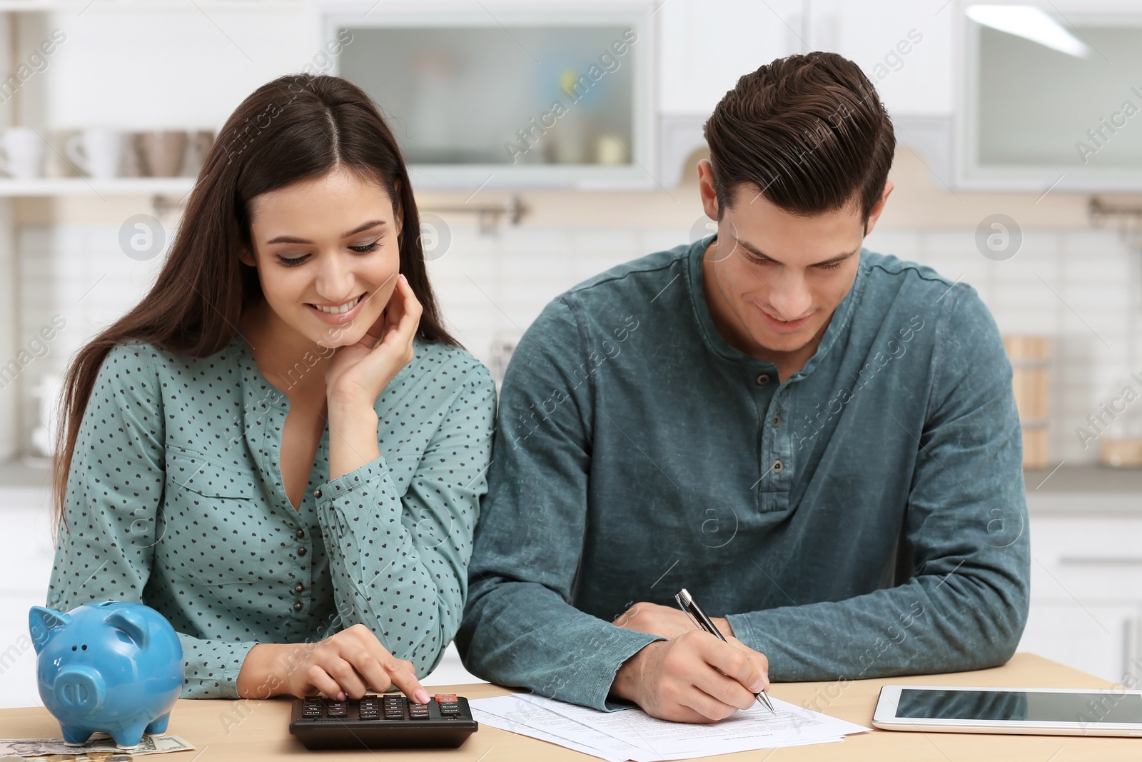 Photo of Young couple discussing pension plan at home