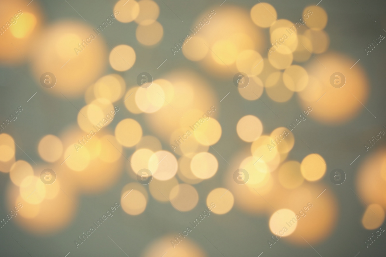 Photo of Blurred view of shiny gold lights. Bokeh effect