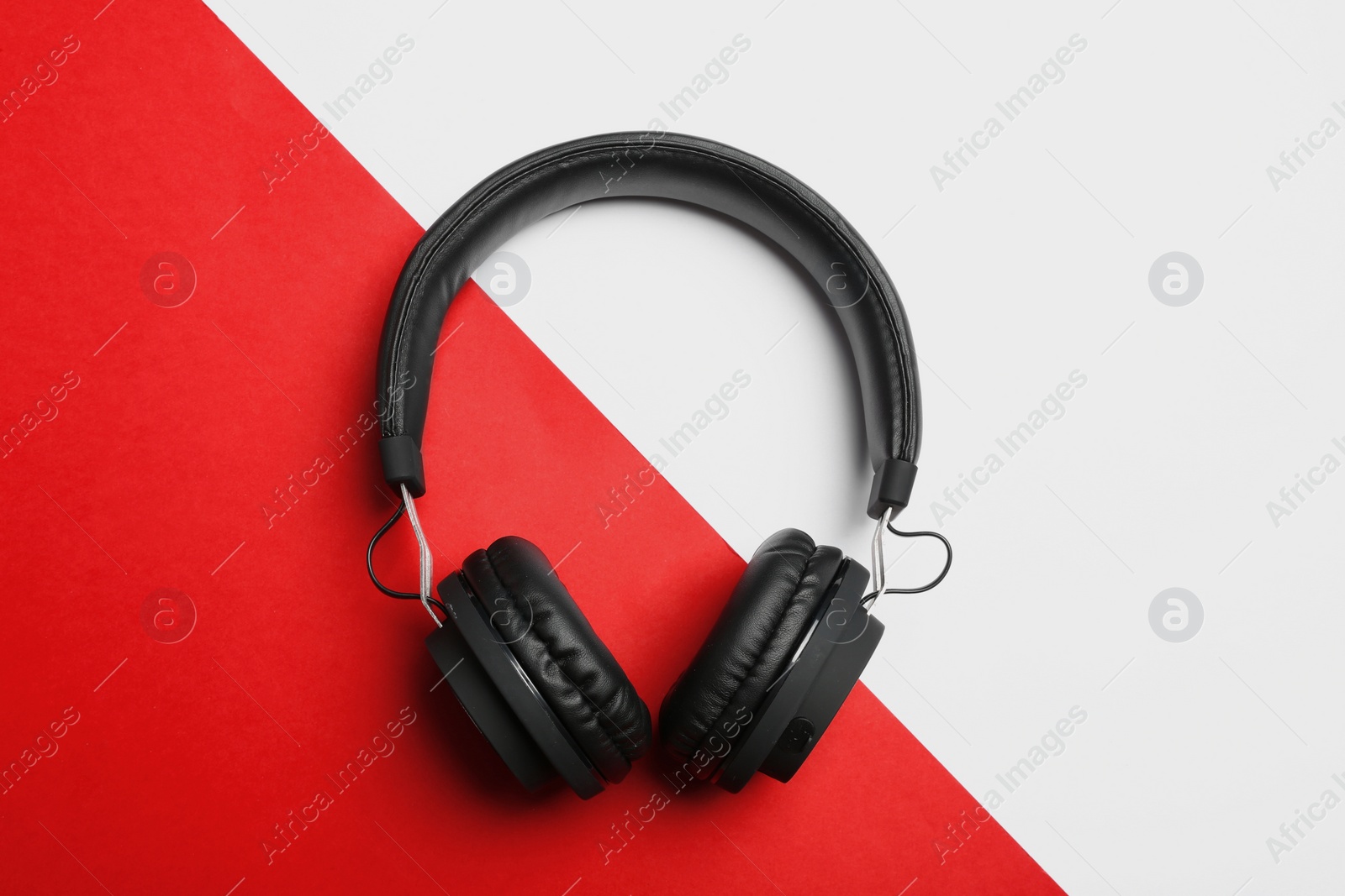 Photo of Stylish headphones on color background, top view