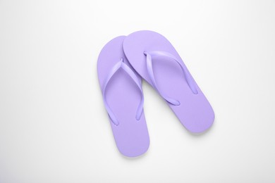 Stylish violet flip flops on white background, top view
