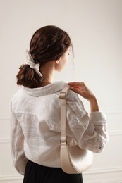 Photo of Woman with stylish bandana on light background