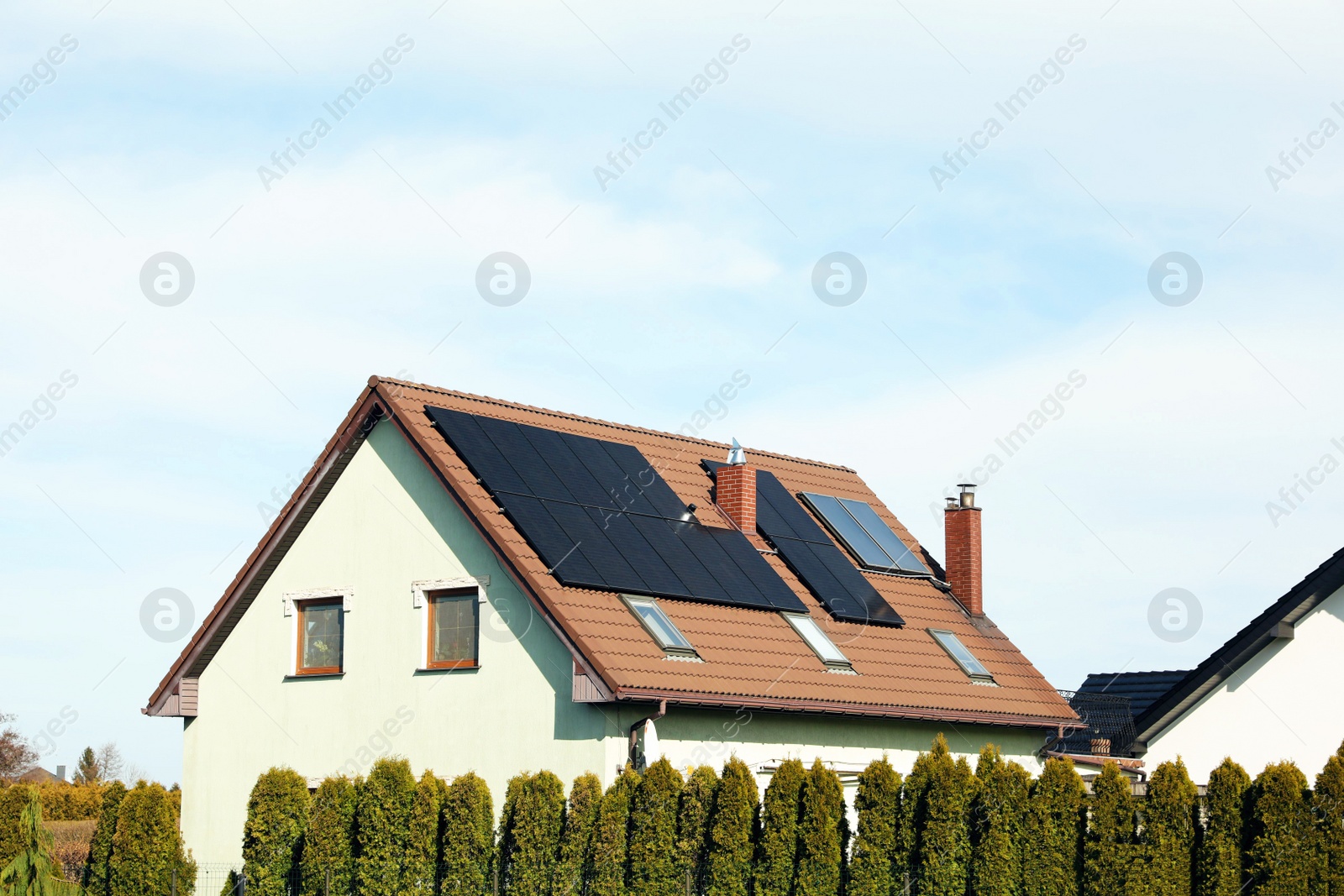 Photo of House with installed solar panels on roof, space for text. Alternative energy