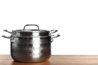 Photo of Stack of clean saucepans on table against white background, space for text