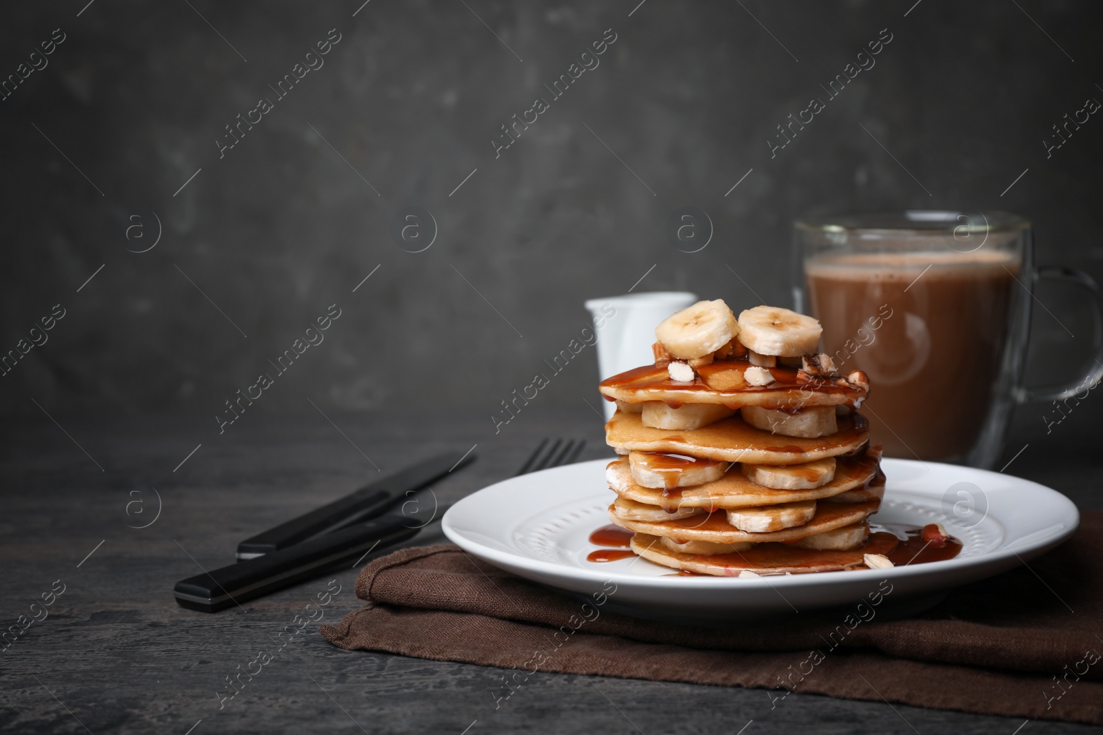 Photo of Plate with delicious pancakes on table