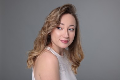 Portrait of beautiful woman on grey background