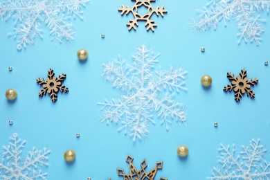 Photo of Flat lay composition with Christmas  balls and snowflakes on blue background