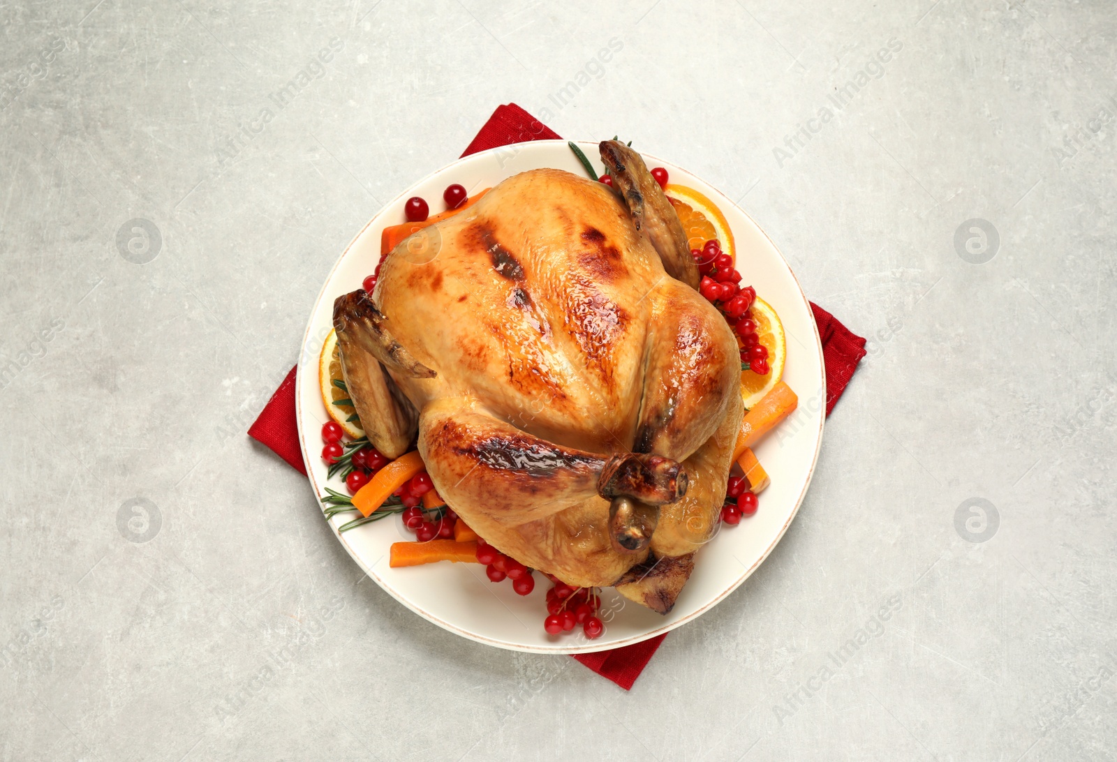 Photo of Delicious cooked turkey served on light table, flat lay. Thanksgiving Day celebration