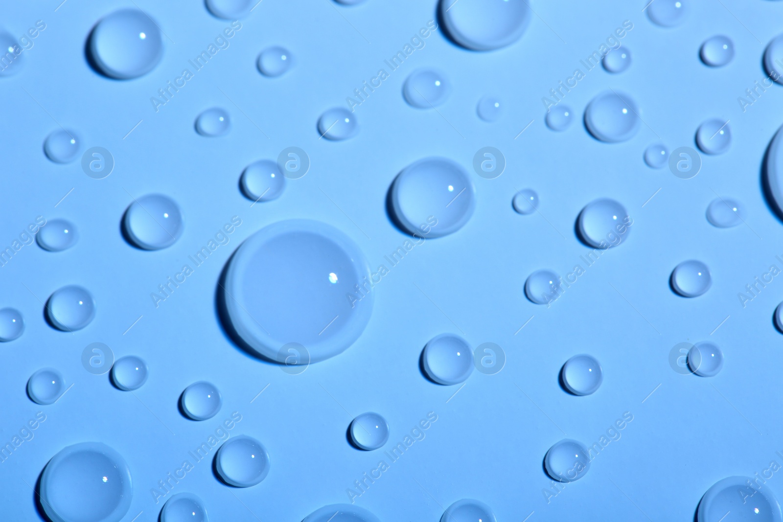 Photo of Water drops on color background, top view