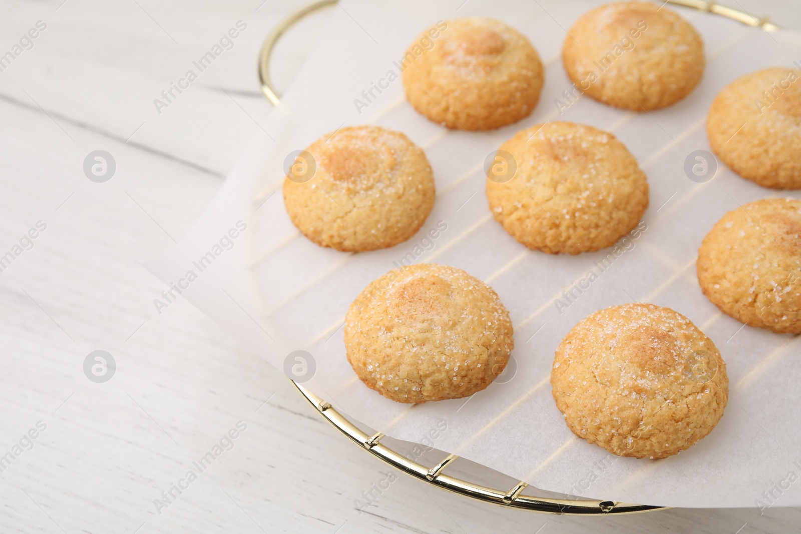 Photo of Tasty sweet sugar cookies on white wooden table, closeup. Space for text