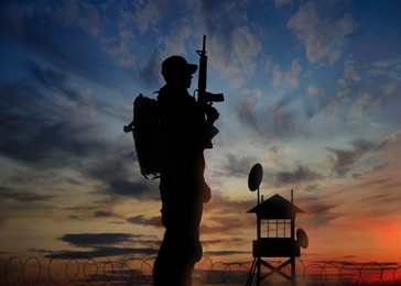 Image of Silhouette of border guard at post outdoors in evening