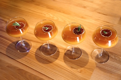 Glasses of delicious cocktail with vodka on wooden counter in bar