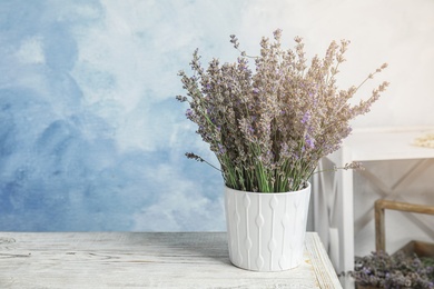 Photo of Pot with blooming lavender flowers on table