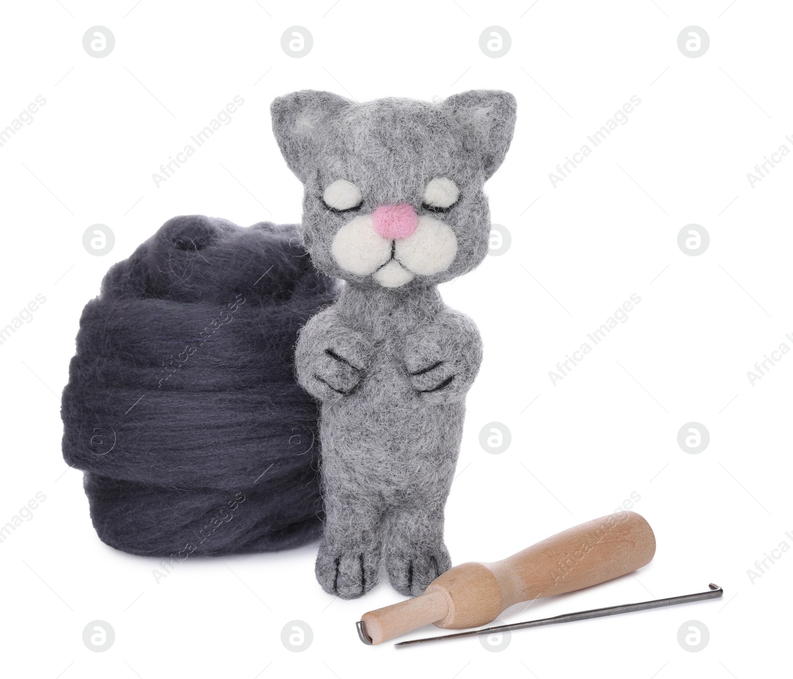Photo of Needle felted cat, wool and tools isolated on white