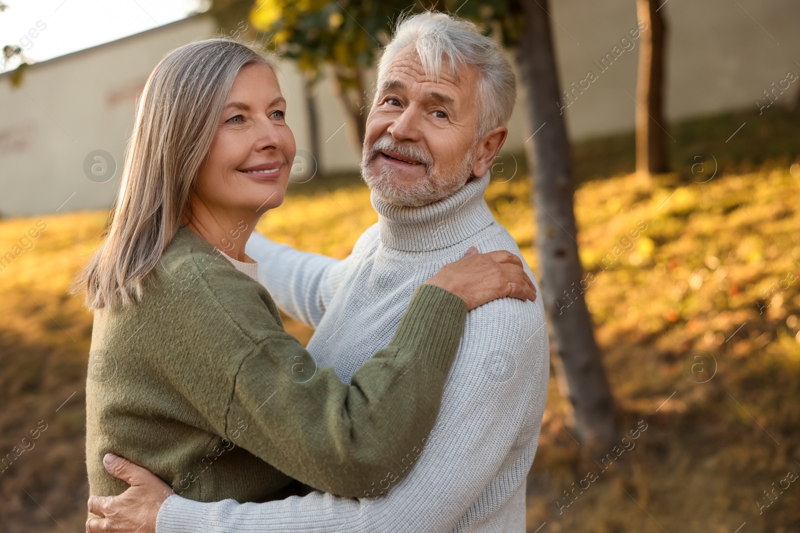 Photo of Affectionate senior couple dancing together outdoors. Romantic date