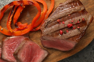 Photo of Delicious grilled beef steak with spices on table, top view
